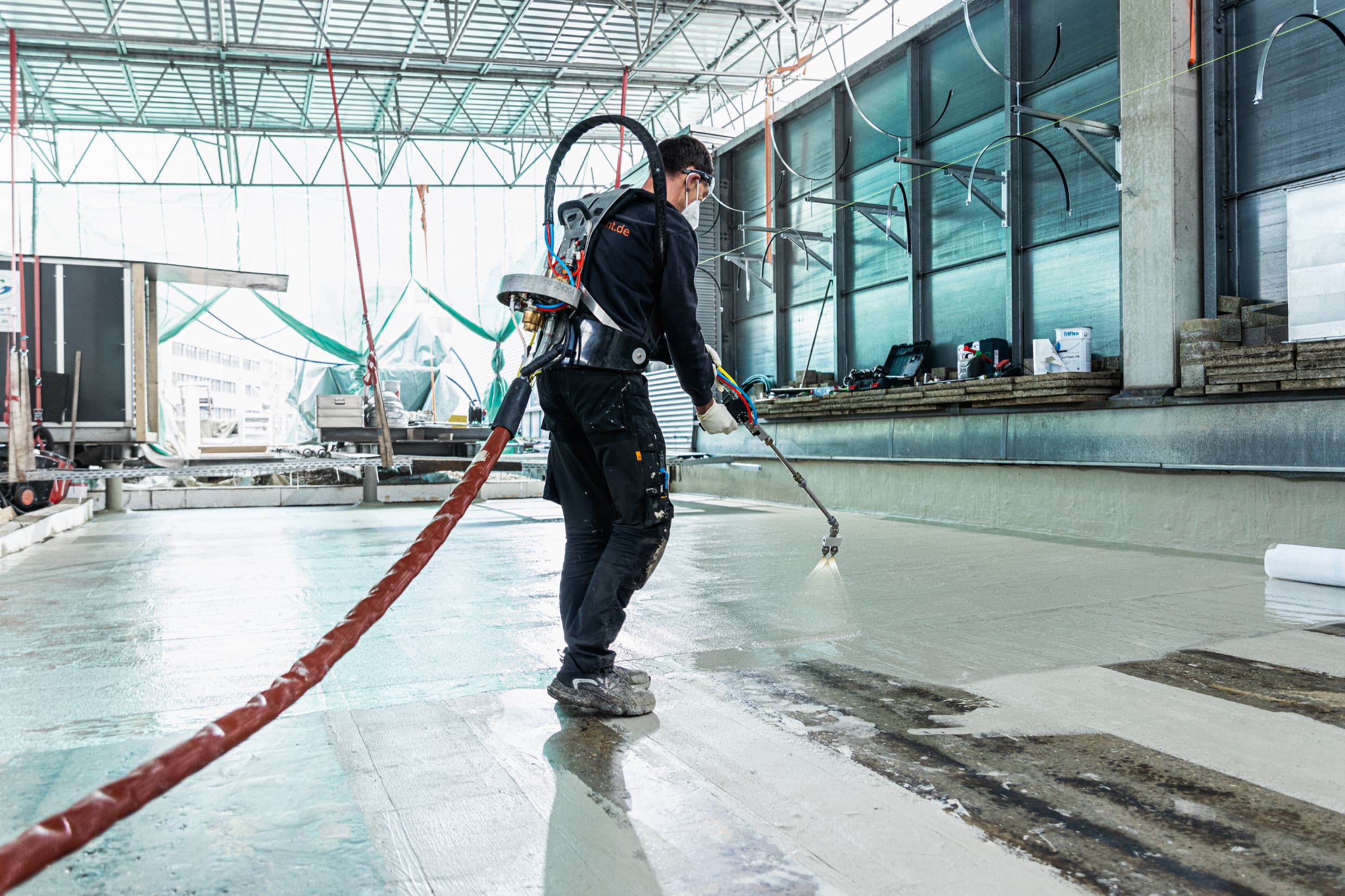 Installation of a Triflex liquid polymer system on an industrial roof